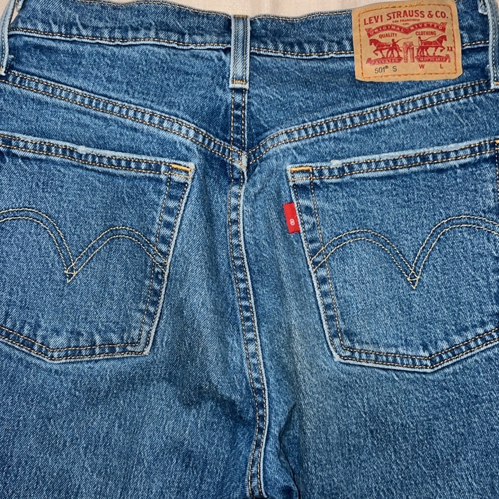 blue straight legged ripped jeans